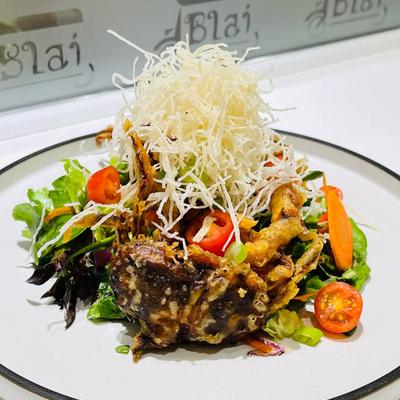 Crispy soft shell crab on fresh greens.