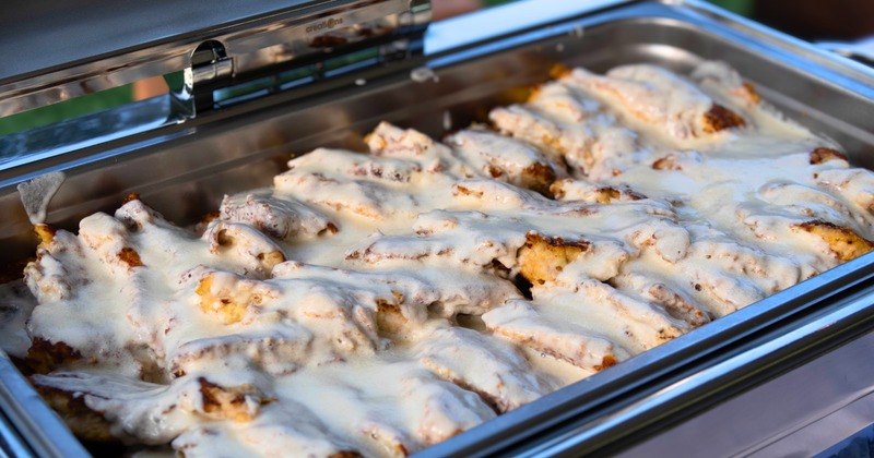 A chafing dish filled with a creamy, savory dish