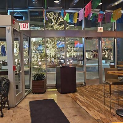 Restaurant entrance with glass doors and windows.