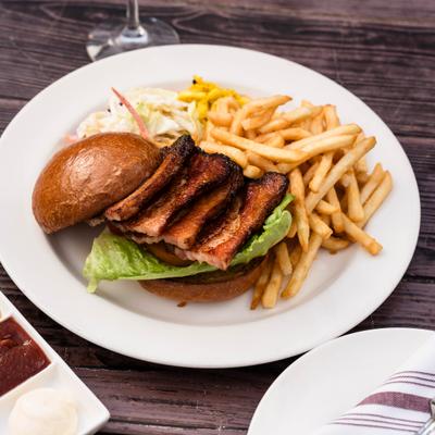 Baker's Farm Baconator BLT sandwich served with fries and coleslaw.