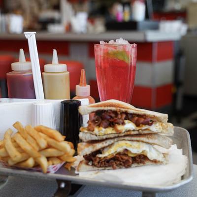 french fries bacon egg and cheese sandwich with cherry limeade.