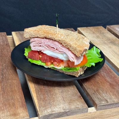 Half ham sandwich on wheat.