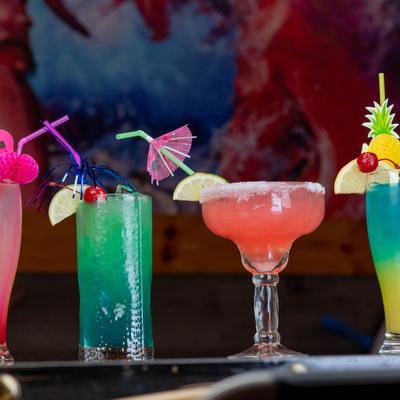 Colorful cocktails with fruit garnishes.