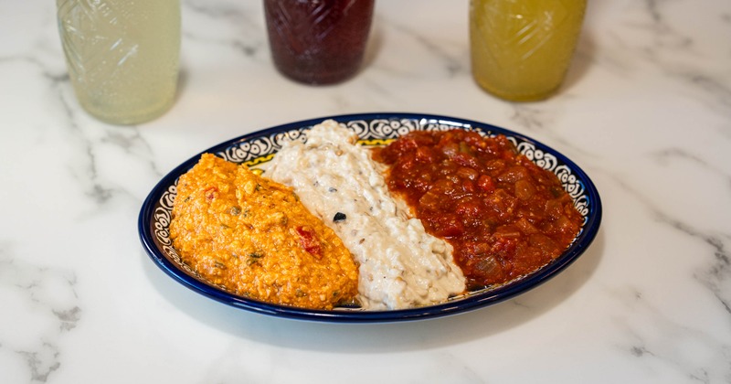 Appetizer platter with three different dips and sauces
