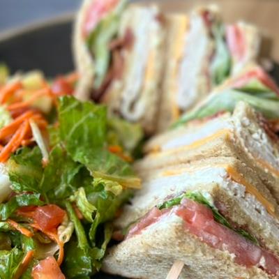Club sandwich and salad, close up.
