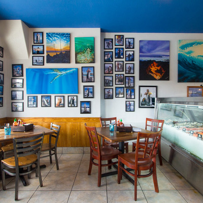 Interior seating area with many photos and paintings on the wall