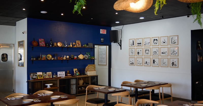 Dining area with set tables, decorative items and framed art on walls