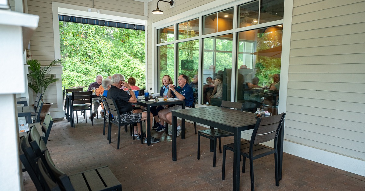 Outdoor seating area with guests enjoying their food and drinks