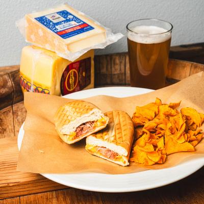 Rockin Reuben Panini sandwich, with chips and beer.