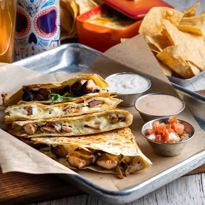 Chicken quesadilla served with pico de gallo and sauces.