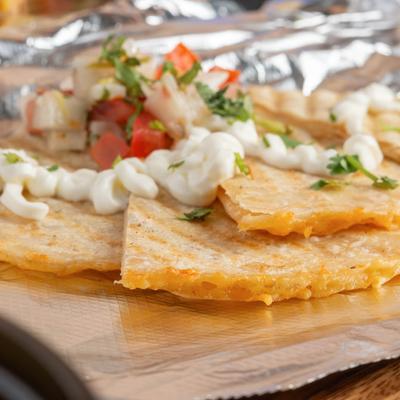 Quesadillas, with sour cream, and pico de gallo.