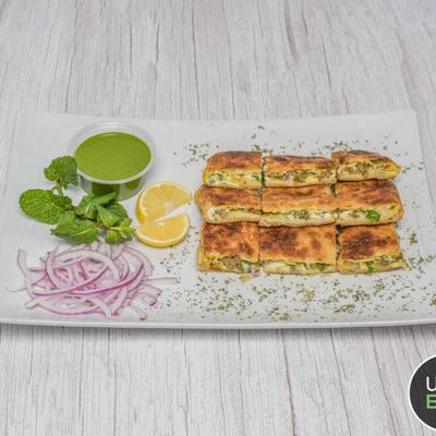 Stuffed paratha flatbread, served with green chutney, sliced onions, lemon, and mint.