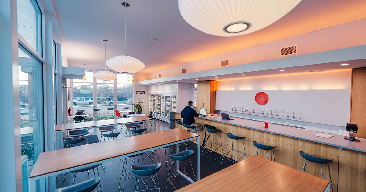 Interior, bar on the left, high seating tables with bar stools, large lanterns