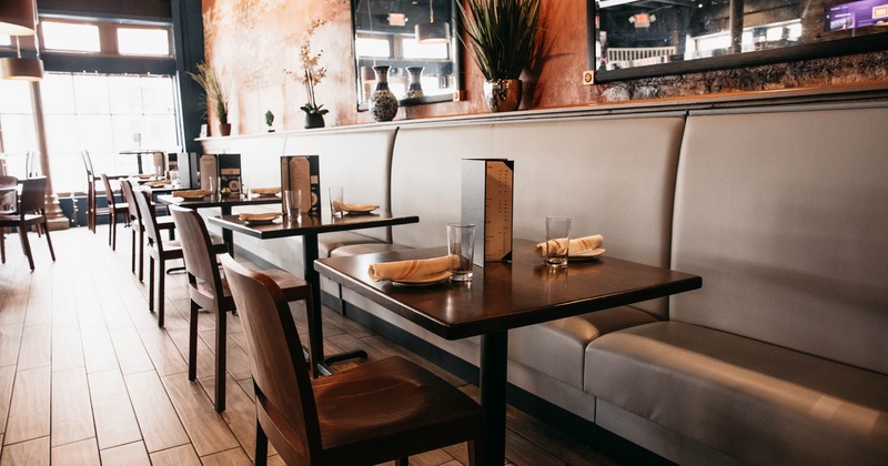 Interior, high back booth seating with tables and chairs