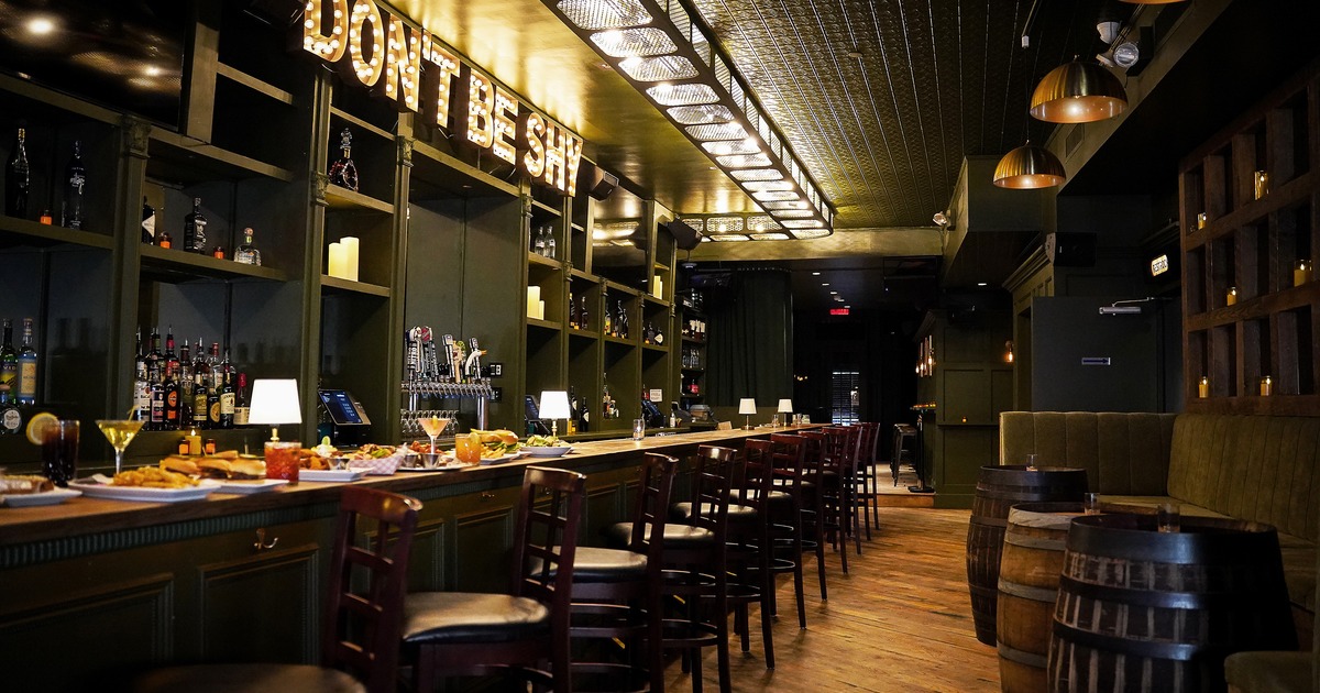 Stylish interior space with a long wooden bar counter with high stools