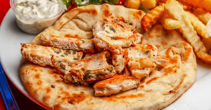 Grilled chicken gyro with fries, salad, and tzatziki