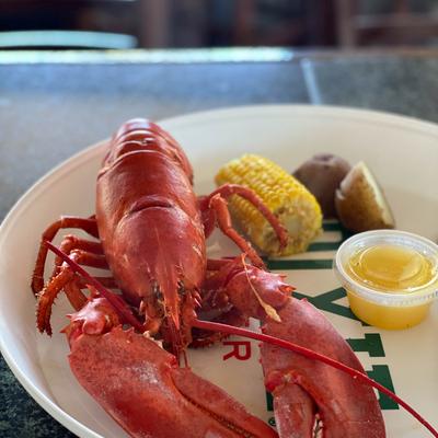 Boiled lobster, potato, corn, and butter.