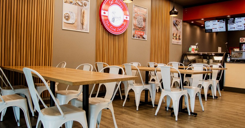 Interior, tables and white chairs in seating area