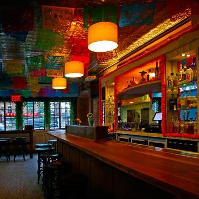 Interior, seating area, tall table, bar counter and chairs.