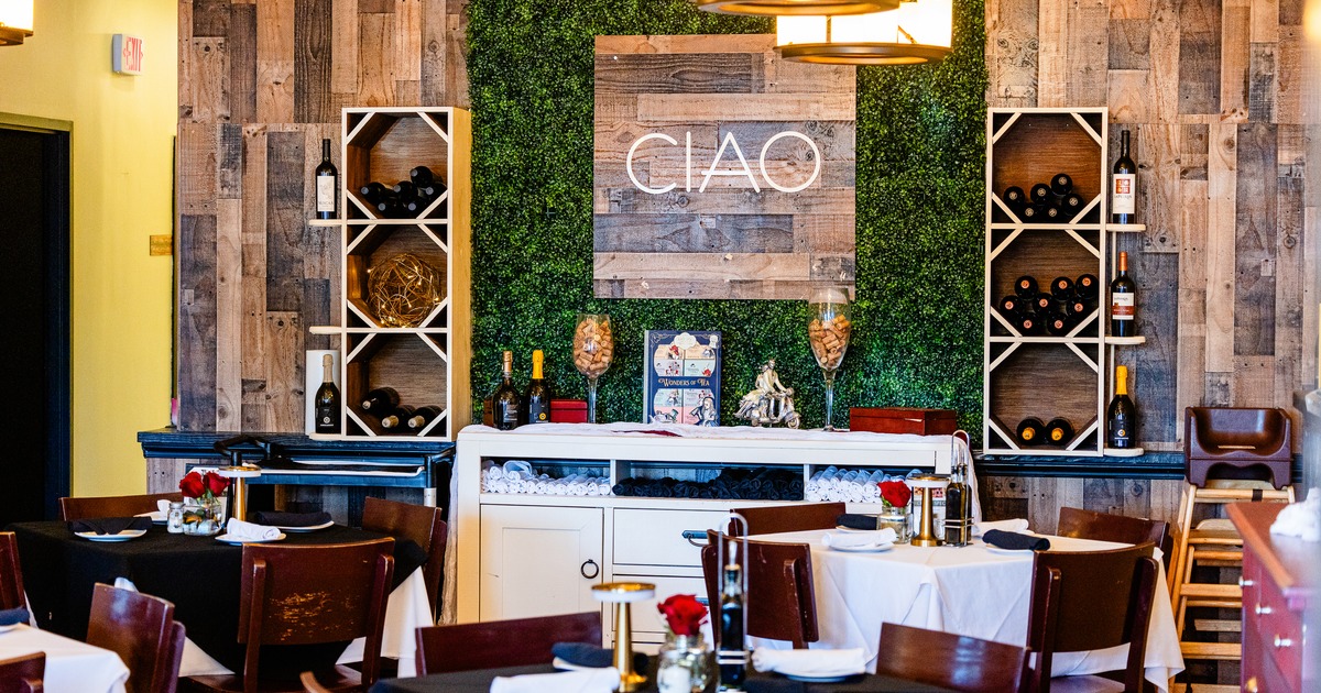 Diner area, tables, chairs, wine shelf behind