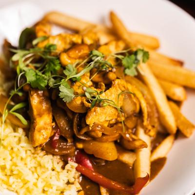 Chicken curry with rice and fries.