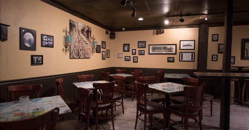 Interior, tables and wooden chairs with leather padding, decorated walls