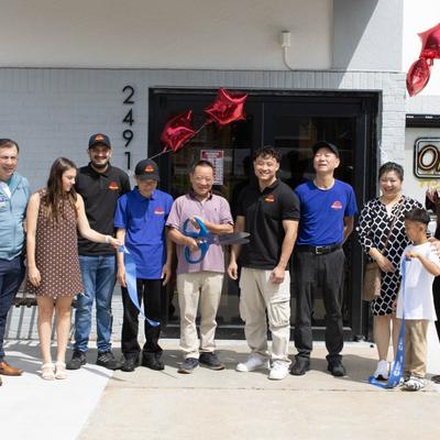 Restaurant opening ceremony with giant scissors.