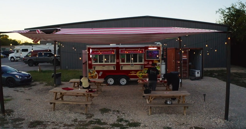 Exterior, parasol, food truck, tables, benches, wide view