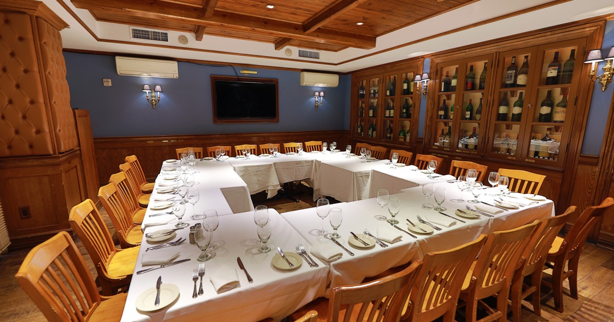 The Balthazar Room with an elegant set tables in a square shape