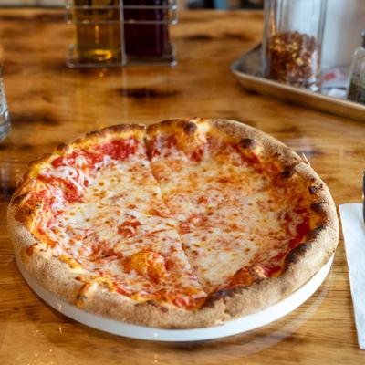 Say Cheese Pizza sliced and served on the table.