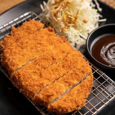 Fried breaded pork cutlet, with cabbage and sauce
