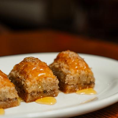 Baklava pieces drizzled with honey.