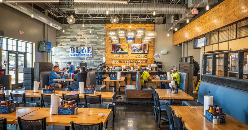 Interior, tables, chairs and blue leather high back benches