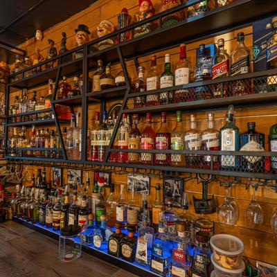 Bar shelves filled with assorted liquor bottles.