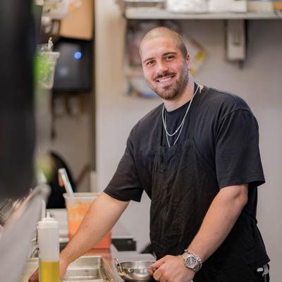 Person posing in a kitchen setting.