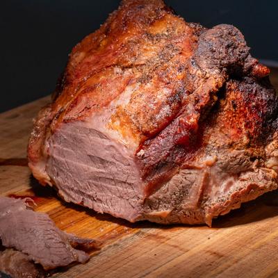A succulent roast on a wooden cutting board.