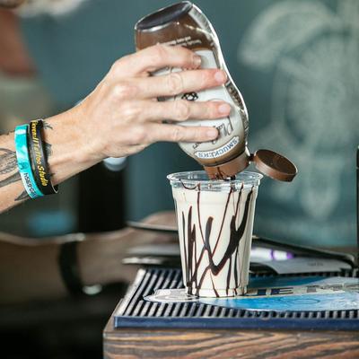 Hands preparing a drink.