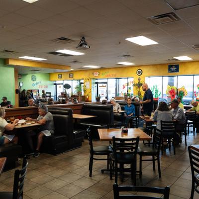 Guests dining at tables.