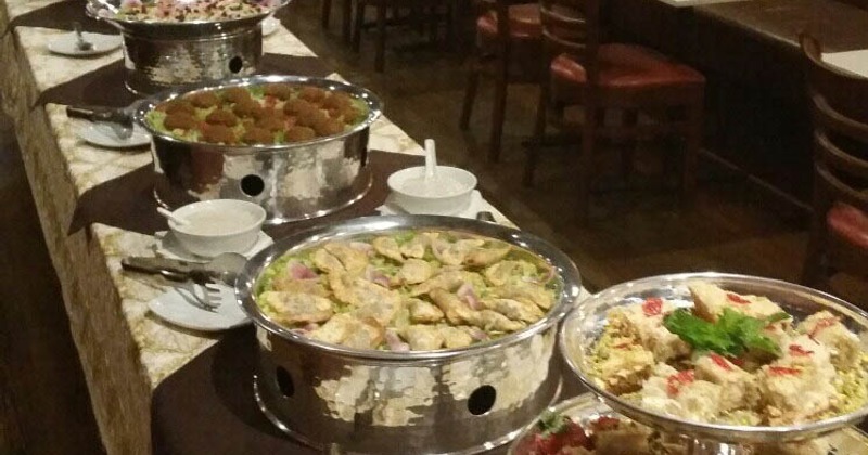 A buffet table displaying a variety of dishes