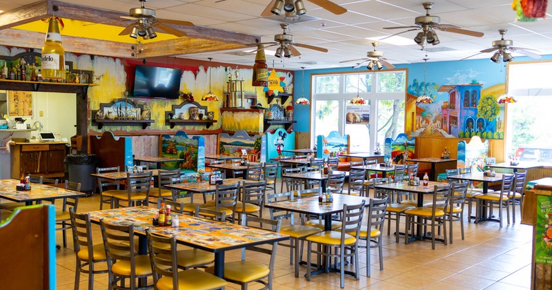 Interior seating area with chairs and tables, colorful decoration
