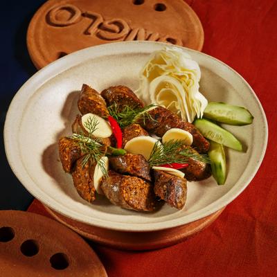 Spiced sausage slices with cucumber and cabbage.