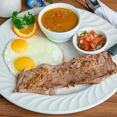 Steak and two sunny side up eggs, served with pico de gallo and bean soup.