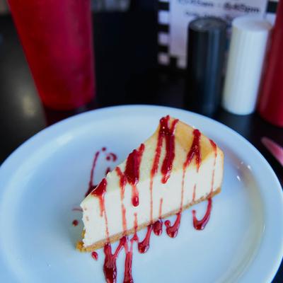 Cheesecake with fruit drizzle.