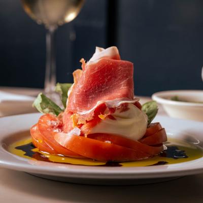 Burrata and prosciutto appetizer.