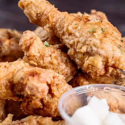 Crispy fried chicken served with a dipping sauce, close up.
