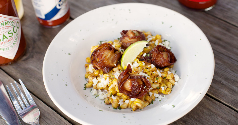 Seared scallops atop corn with white cheese
