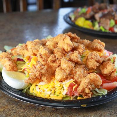 Popcorn Chicken Salad, with cheddar, jack cheese, eggs, lettuce, and tomatoes.