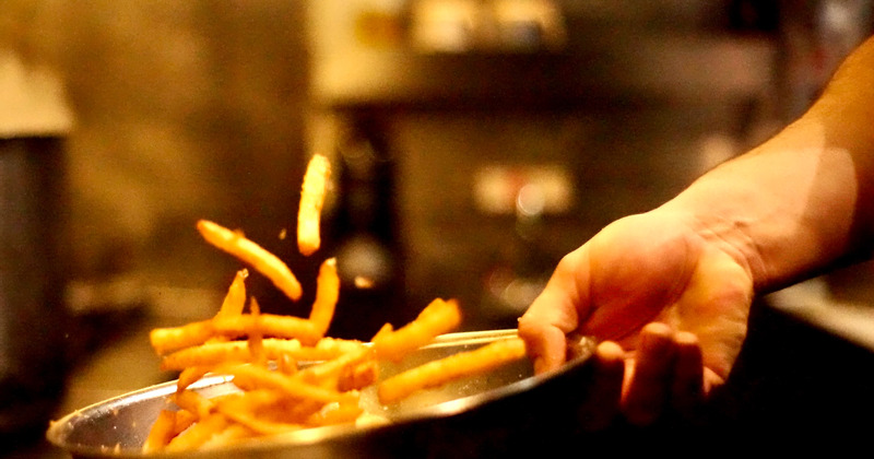 A chef preparing French fries