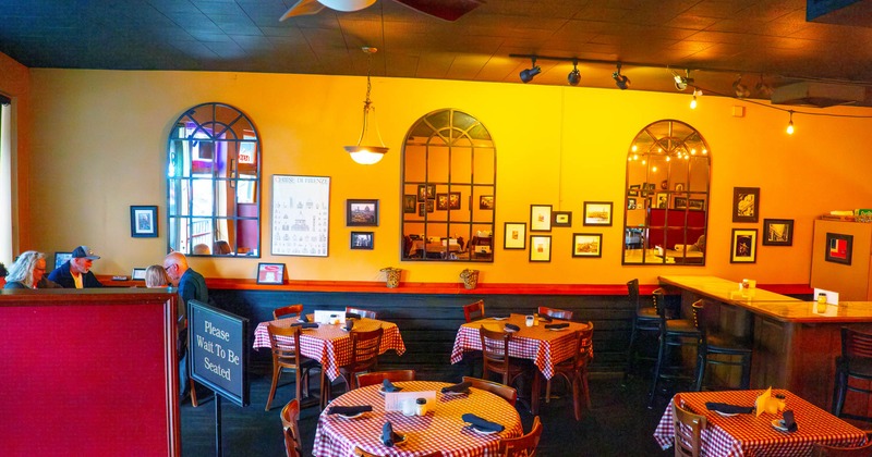 Interior, dining tables and chairs ready for guests