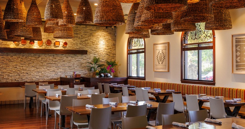 Interior, dining area with long seating bench near window and tables and chairs